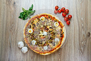 Pizza with red sauce, mozarella, ham, mushroom, boiled egg, green olives top