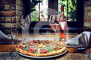 Pizza and red wine on the table
