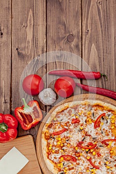 Pizza and red wine on wooden table background. Top view with copy space