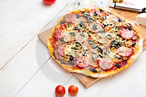 Pizza and red wine on wooden table background. Top view with copy space