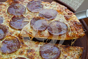 Pizza with salami and chorizo. Melted, dark. photo