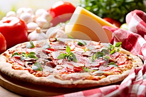 Pizza with salami, ham and vegetables