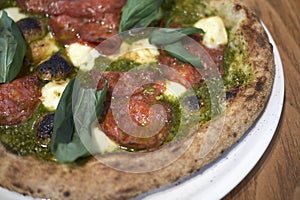 Pizza with salami and pesto