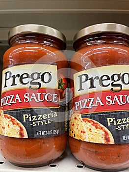 Pizza sauce kits on a retail store shelf Prego in a jar