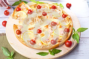 Pizza with seafood red fish, salmon, shrimp, tomatoes, still life, cheese, stretches, shoulder, slice, rises