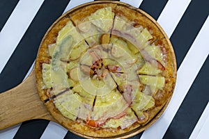 Pizza served on wooden circle board