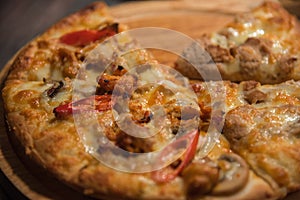 Pizza served on wooden circle board