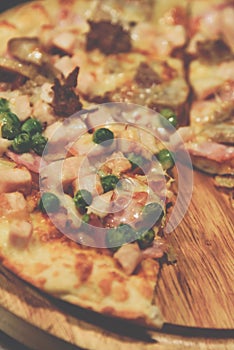 Pizza served on wooden circle board