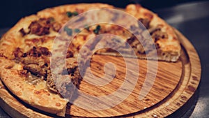 Pizza served on wooden circle board