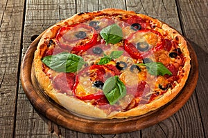 Pizza served on wooden plate