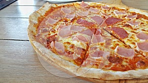 Pizza slice on wooden table