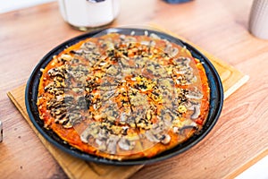 Pizza sliced on a black tray