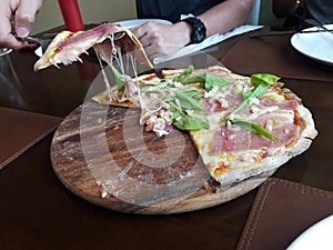 Pizza with smoked salmon and cheese and rocket vegetable