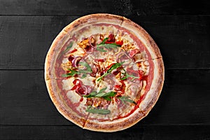 Pizza with sous vide chicken, bacon, salami, spicy pepper, onion and arugula