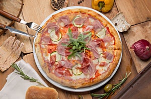 The pizza on the table and vegetables