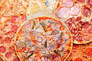 Pizza texture, food background. Assorted delicious pizzas total