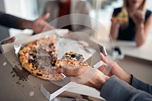 Pizza on today`s menu in a break at company`s canteen. People, job, company, business concept photo