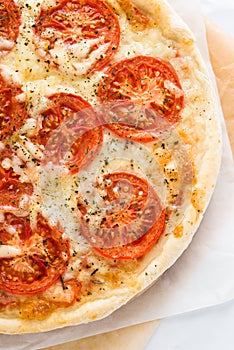 Pizza with tomato, cheese and dry basil on white background top view