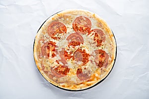 Pizza with tomato, cheese and dry basil on white background top view