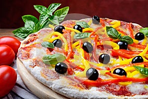 Vegetable pizza with tomato, mozzarella, peppers, olives and fresh basil. photo