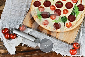 Tasty Pizza With Tomato Sauce, Pepperoni Sausage, And Mushrooms On Wooden Background Natural Rustic, A Pizza Cutter And Ingridient