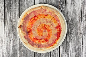 Pizza with tomato sauce on wooden background. Top view, close-up