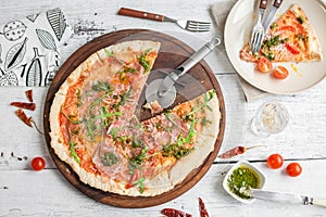 Pizza with tomatoes and pesto sauce