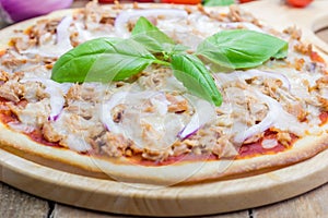 Pizza with tuna fish on a wooden board