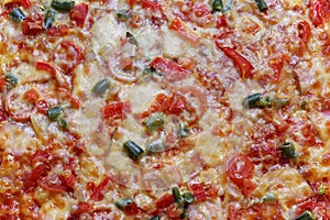 Pizza with vegetables and meat close-up as a background.