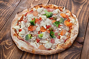 Pizza vegetariana on wooden background, side view photo