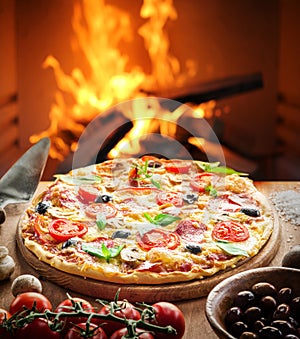 Pizza. Wood-fired oven on the background. photo