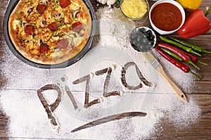 Pizza word written in flour, ingredients, making pizza