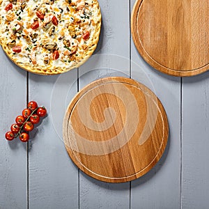 Pizzas on wooden boards top view