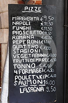 pizzeria board with the list of all the pizzas with the various flavors written in Italian and French