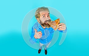 Pizzeria. Pizza time. Bearded man eating tasty pizza showing thumb up. Italian cuisine. Lunch or dinner. Handsome guy in