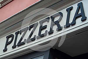 Pizzeria sign on italian restaurant facade