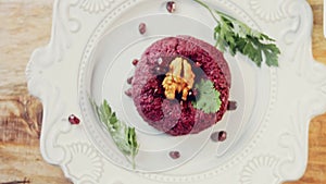 Pkhali traditional Georgian food. Beetroot is used for the purple color. Walnut is used for decoration, lens distortion