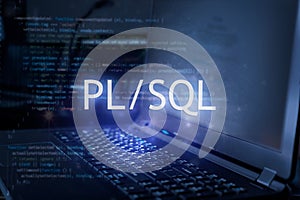 PL/SQL inscription against laptop and code background. Learn pl/sql programming language, computer courses, training