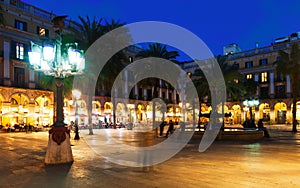 Placa Reial with fountain and restaurants in evening. Barcelona