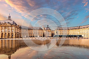 Place de la Bourse and its reflecting pool and a passing tram, in Bordeaux in New Aquitaine, France