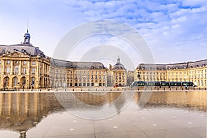 Place de la Bourse and its reflecting pool and a passing tram, in Bordeaux in New Aquitaine, France