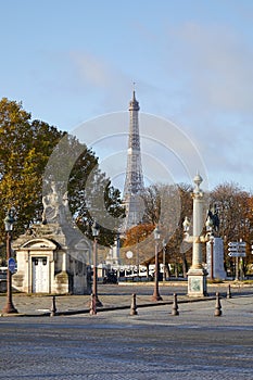 Place de la Concorde with golden and green street lamps and Eiffel tower in a sunny autumn day in Paris, France