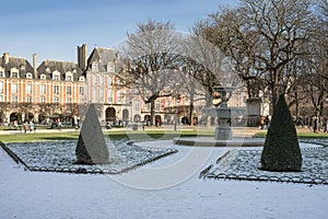 Place des Vosges is one of the oldest planned squares in Paris, lined with trees and red brick houses, built by Henri IV in 1612.