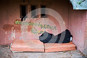 A place near the entrance of a house where a homeless person sleeps. Problems of large modern cities.