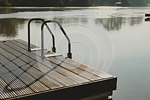 Place for people meeting or gathering place in a city on a river with wooden platform and handrails