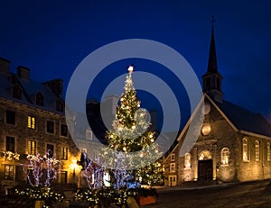 Place Royale Royal Plaza and Notre Dame des Victories Church decorated for Christmas at night - Quebec City, Canada photo