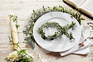 Place setting of christian evening like a christening or holy communion.