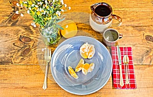 Place Setting With Orange Peels on Wooden Table With Knots