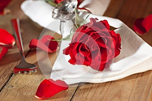 Place setting with a red rose in country style