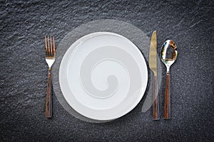 Place setting table food with set of white plate on table cloths or napkin on the dinner / empty plate spoon fork and knife on